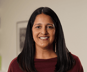 A headshot of Renee wearing smart dark clothing.