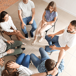 A mixed group therapy session viewed from above